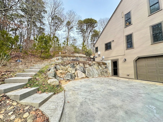 view of yard with a garage and stairs