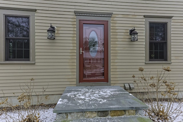 view of snow covered property entrance