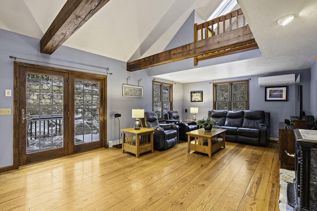 living room featuring a wall unit AC, light wood-type flooring, lofted ceiling with beams, a baseboard radiator, and a wood stove