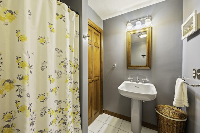 bathroom with curtained shower and tile patterned floors