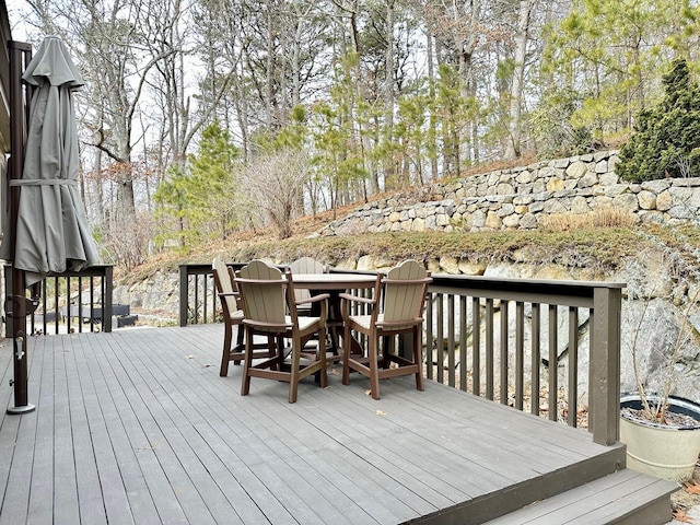 wooden terrace with outdoor dining space