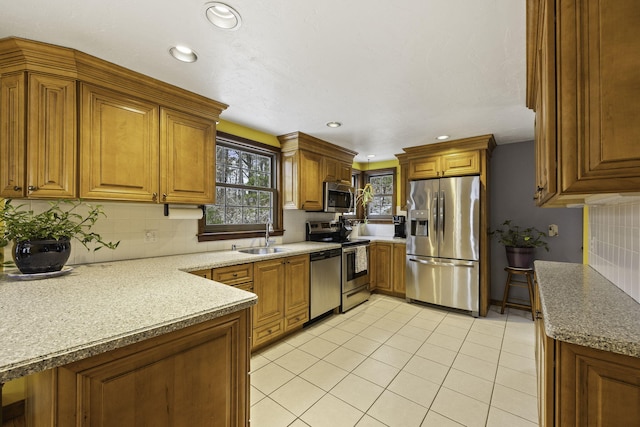 kitchen with sink, light tile patterned floors, stainless steel appliances, tasteful backsplash, and light stone counters