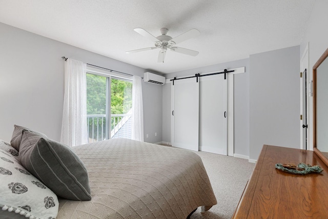 288 Fletcher Ln, Brewster, MA 02631 - bedroom featuring a wall mounted AC, access to outside, a barn door, carpet floors, and ceiling fan