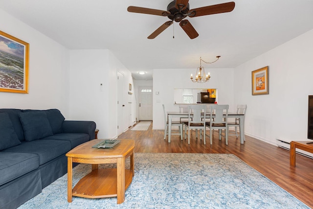 288 Fletcher Ln, Brewster, MA 02631 - living area featuring wood finished floors, a chandelier, and a ceiling fan