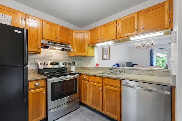 288 Fletcher Ln, Brewster, MA 02631 - kitchen featuring stainless steel appliances, under cabinet range hood, light tile patterned floors, backsplash, and brown cabinets