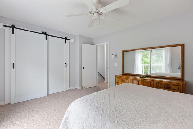 288 Fletcher Ln, Brewster, MA 02631 - carpeted bedroom with a barn door and ceiling fan
