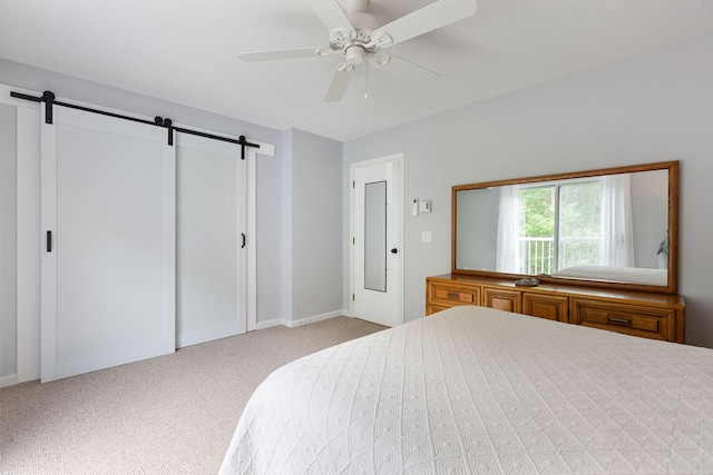 288 Fletcher Ln, Brewster, MA 02631 - carpeted bedroom featuring a barn door and ceiling fan