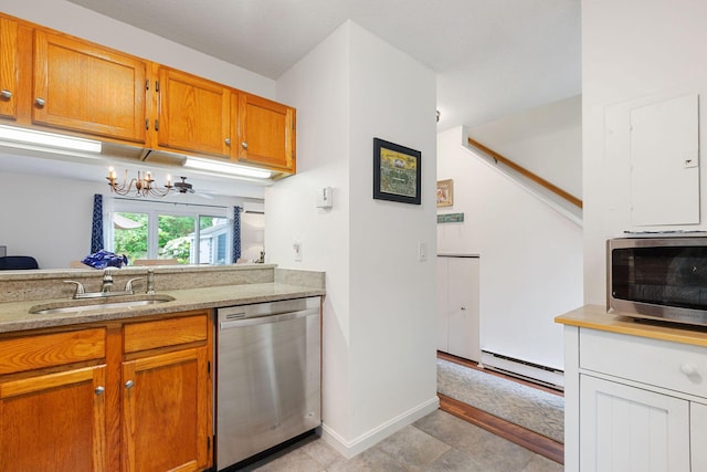288 Fletcher Ln, Brewster, MA 02631 - kitchen with stainless steel appliances, a chandelier, brown cabinets, baseboard heating, and light stone countertops