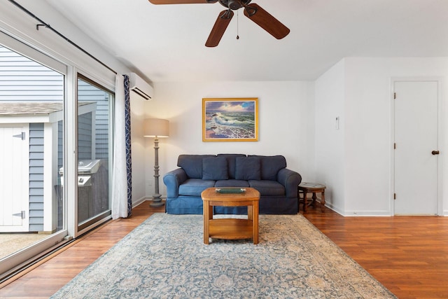 288 Fletcher Ln, Brewster, MA 02631 - living room with wood finished floors, ceiling fan, and a wall unit AC