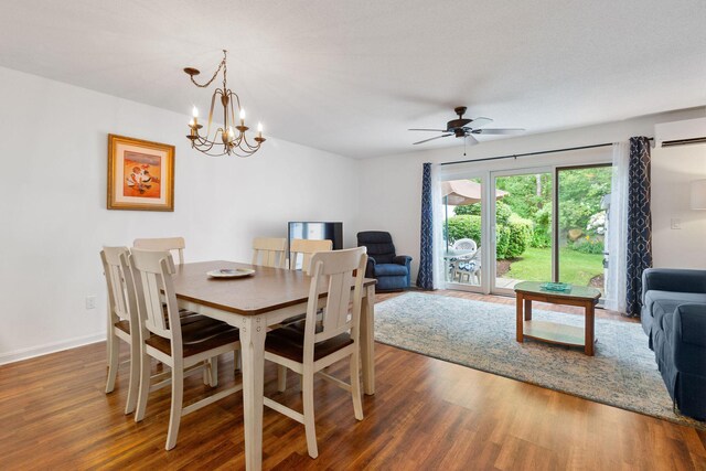 288 Fletcher Ln, Brewster, MA 02631 - dining room with a wall unit AC, wood finished floors, a ceiling fan, and a chandelier