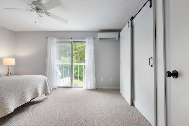 288 Fletcher Ln, Brewster, MA 02631 - bedroom with a wall mounted AC, a barn door, carpet, access to exterior, and a ceiling fan