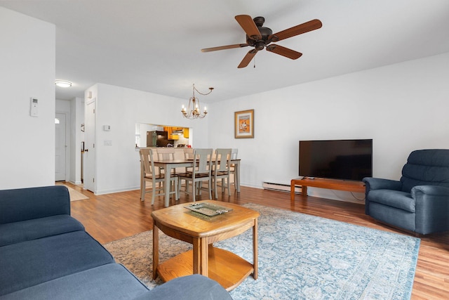 288 Fletcher Ln, Brewster, MA 02631 - living area with wood finished floors, a chandelier, a ceiling fan, and baseboard heating