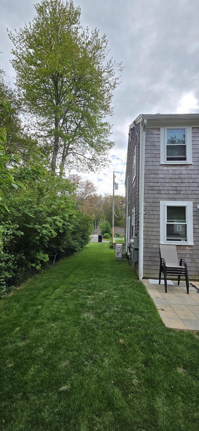 46B Beach Rd Unit 2, West Yarmouth, MA 02673 - view of green lawn with a patio