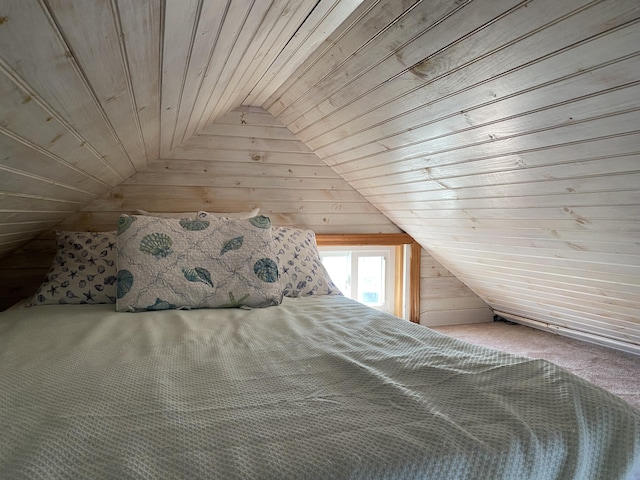 unfurnished bedroom featuring vaulted ceiling, wood walls, and wooden ceiling