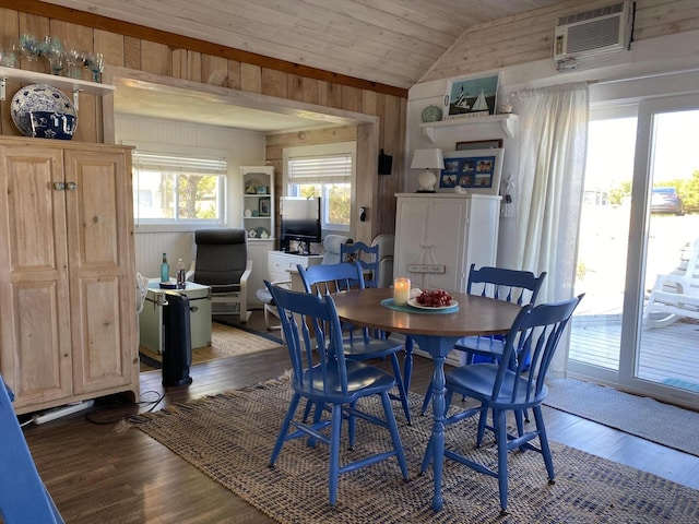 dining area with wood ceiling, wood-type flooring, wooden walls, a wall unit AC, and vaulted ceiling