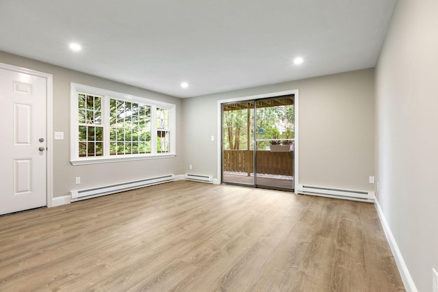 1029 Iyannough Rd Unit 9B, Hyannis, MA 02601 - unfurnished room with baseboard heating, wood finished floors, baseboards, and recessed lighting