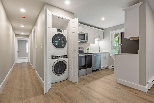 1029 Iyannough Rd Unit 9B, Hyannis, MA 02601 - laundry room with estacked washer and dryer, light wood-style floors, recessed lighting, baseboards, and baseboard heating