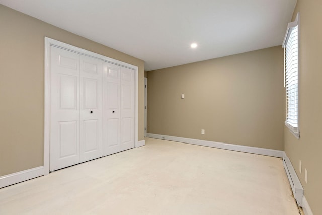 1029 Iyannough Rd Unit 9B, Hyannis, MA 02601 - unfurnished bedroom with a baseboard heating unit, baseboards, multiple windows, recessed lighting, and a closet