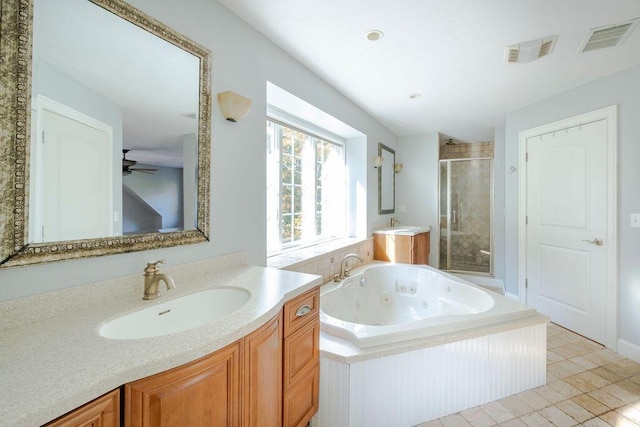 bathroom with vanity and independent shower and bath