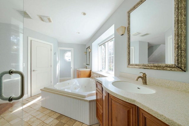 bathroom featuring vanity and a bath