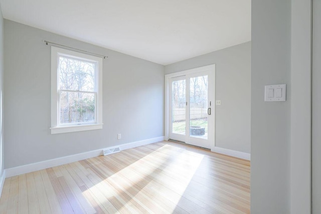 unfurnished room with light hardwood / wood-style floors