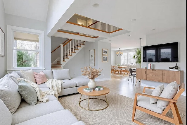 living room with a notable chandelier and light wood-type flooring