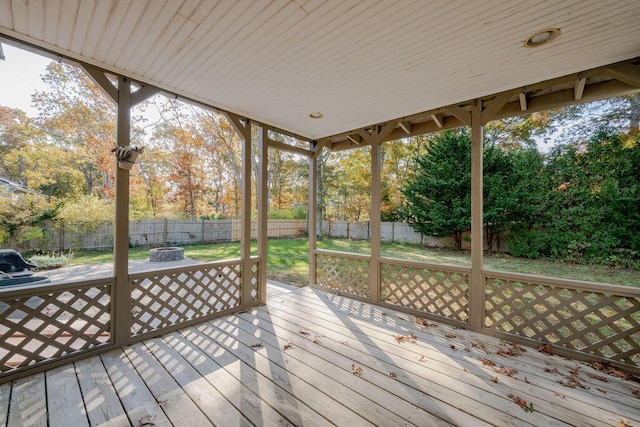 wooden terrace featuring an outdoor fire pit