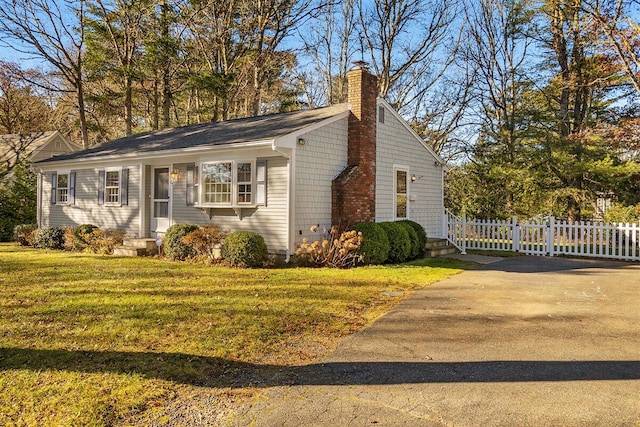 view of side of property with a lawn