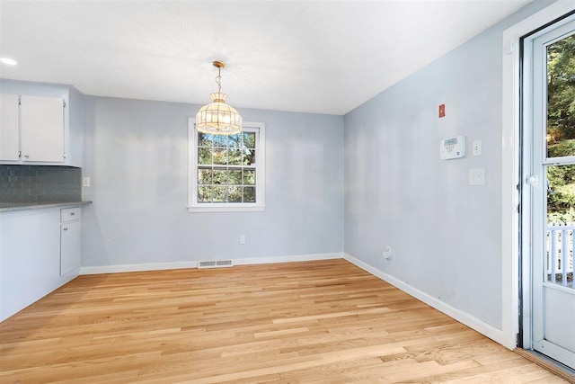 unfurnished dining area featuring light hardwood / wood-style flooring