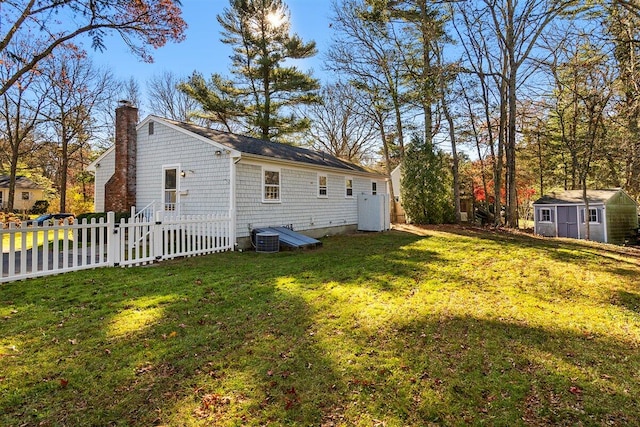 exterior space featuring a storage unit and a lawn