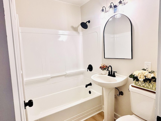 bathroom with toilet and bathing tub / shower combination