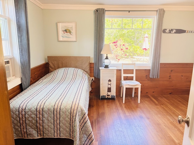 69 Captain Chase Rd, Dennis Port, MA 02639 - bedroom featuring wood finished floors, a wainscoted wall, ornamental molding, and wood walls
