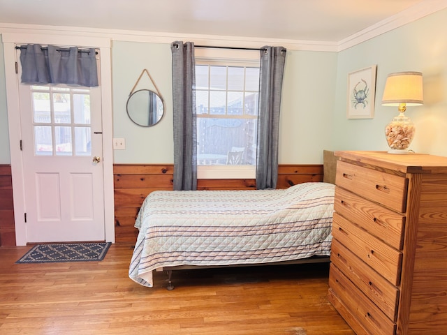 69 Captain Chase Rd, Dennis Port, MA 02639 - bedroom with wood finished floors, a wainscoted wall, ornamental molding, and wooden walls