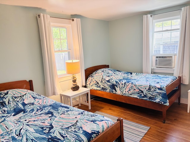 69 Captain Chase Rd, Dennis Port, MA 02639 - bedroom featuring multiple windows, wood finished floors, and cooling unit