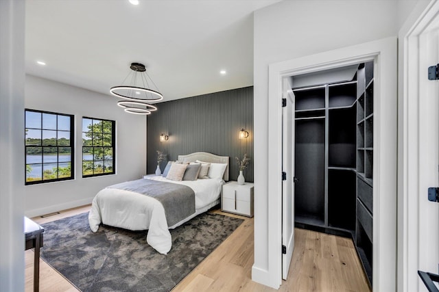 2 Buttercup Ln, South Yarmouth, MA 02664 - bedroom featuring an accent wall, recessed lighting, light wood finished floors, and a chandelier