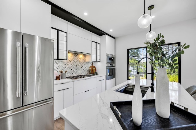 2 Buttercup Ln, South Yarmouth, MA 02664 - kitchen with stainless steel appliances, modern cabinets, decorative backsplash, white cabinets, and recessed lighting