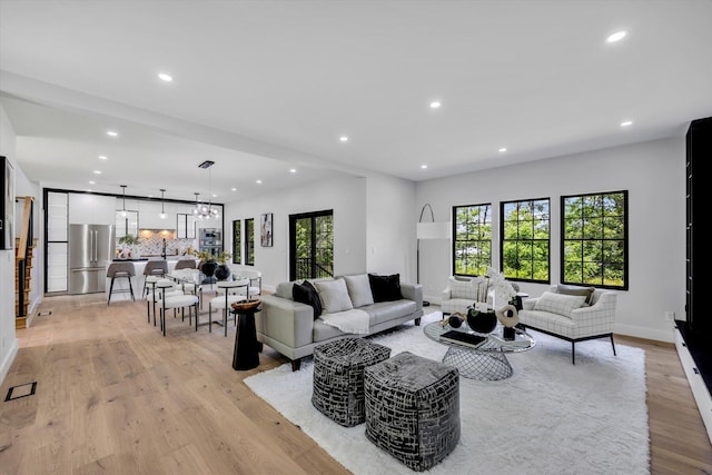 2 Buttercup Ln, South Yarmouth, MA 02664 - living room with recessed lighting, light wood-style flooring, and a chandelier