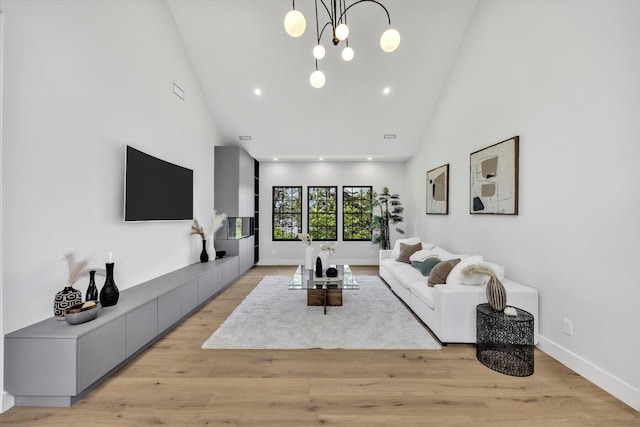 2 Buttercup Ln, South Yarmouth, MA 02664 - living room featuring high vaulted ceiling, light wood-style floors, and a chandelier