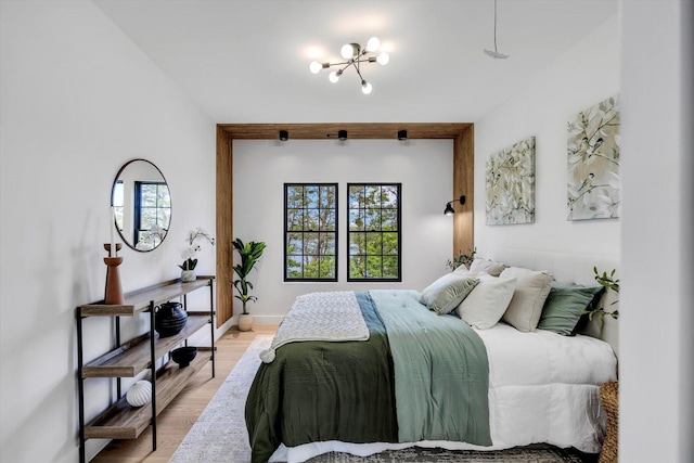 2 Buttercup Ln, South Yarmouth, MA 02664 - bedroom with a chandelier and light wood-style flooring