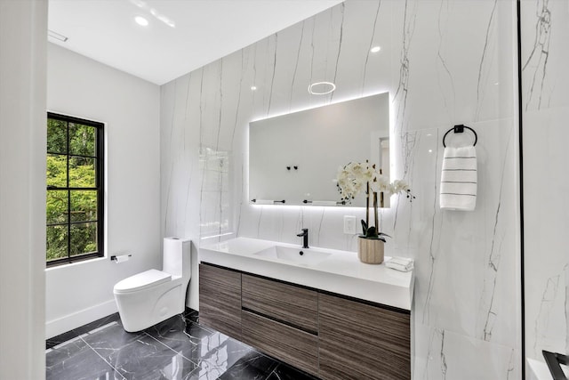 2 Buttercup Ln, South Yarmouth, MA 02664 - bathroom featuring marble tiled floors, vanity, and recessed lighting