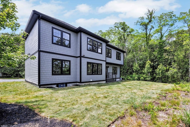 2 Buttercup Ln, South Yarmouth, MA 02664 - rear view of house with a lawn and entry steps