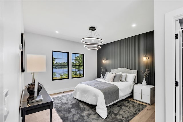 2 Buttercup Ln, South Yarmouth, MA 02664 - bedroom featuring an accent wall, wood finished floors, recessed lighting, and a chandelier