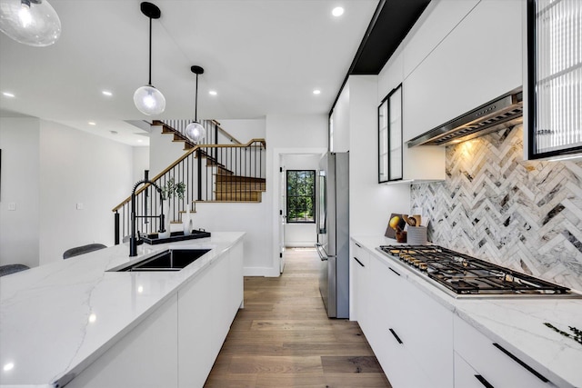 2 Buttercup Ln, South Yarmouth, MA 02664 - kitchen featuring appliances with stainless steel finishes, wood finished floors, custom exhaust hood, decorative backsplash, and recessed lighting