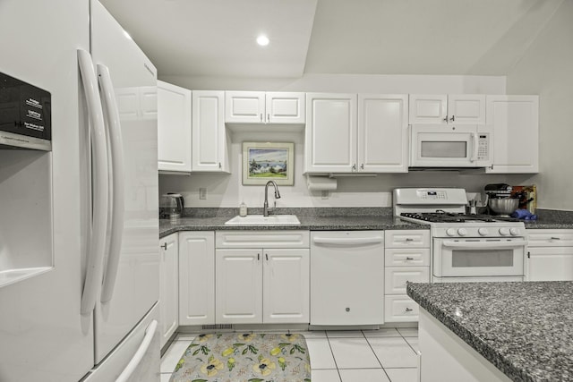 kitchen featuring a sink, recessed lighting, white appliances, white cabinets, and light tile patterned flooring