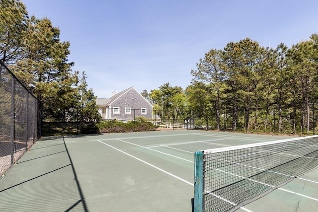 view of tennis court with fence