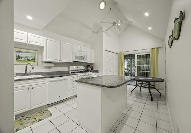 kitchen with a center island, white appliances, white cabinets, sink, and high vaulted ceiling