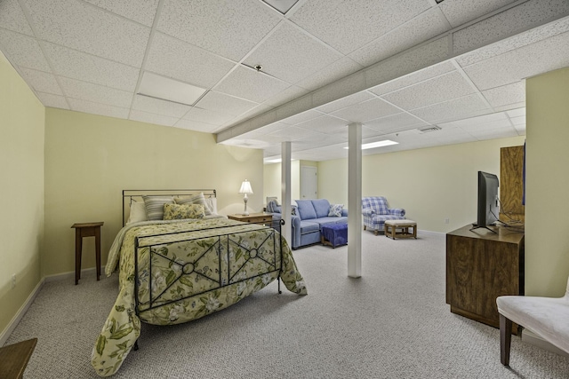 bedroom with light carpet and a drop ceiling