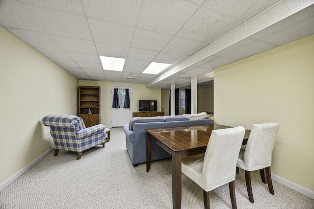 dining space with a paneled ceiling, baseboards, and carpet floors