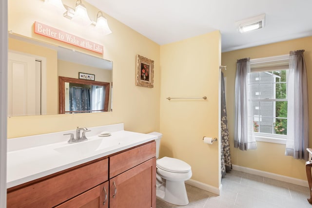 bathroom with vanity, a shower with curtain, baseboards, toilet, and tile patterned flooring