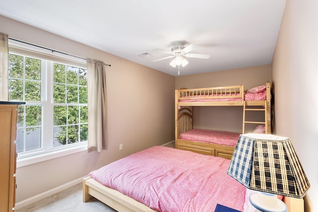 carpeted bedroom with ceiling fan, baseboards, and visible vents